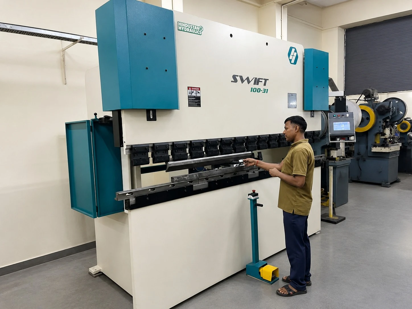Operator working on a Hindustan Hydraulics SWIFT press brake machine