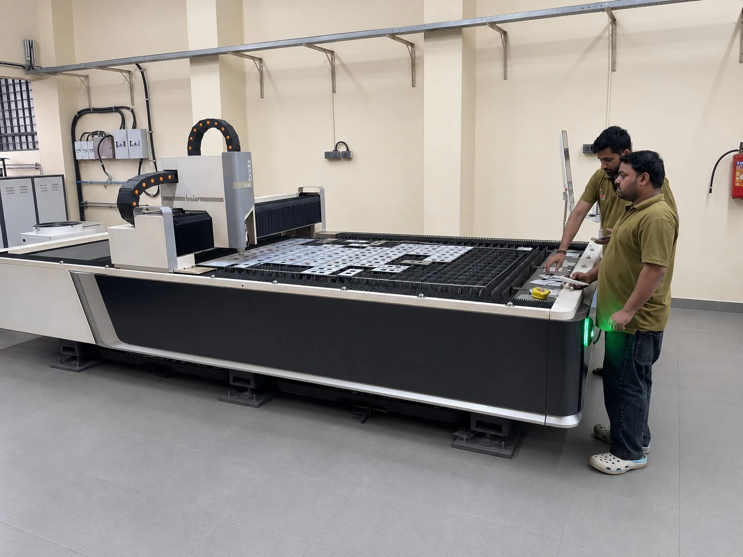 Laser cutting machine working on elevator component sheets